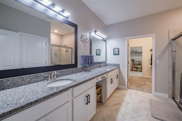 bathroom with walk in shower, tile patterned floors, and vanity