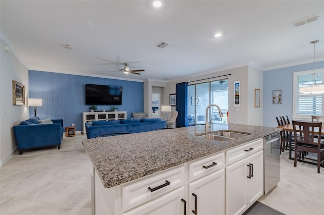 kitchen with sink, dishwasher, a kitchen island with sink, ornamental molding, and white cabinets