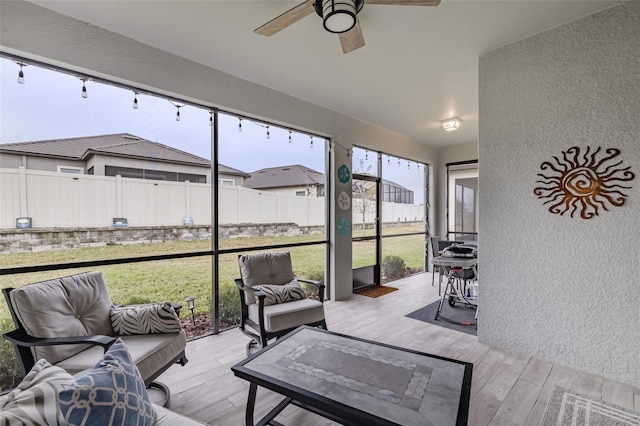 sunroom / solarium featuring ceiling fan