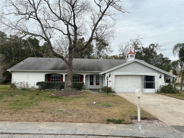 ranch-style house with a garage and a front yard