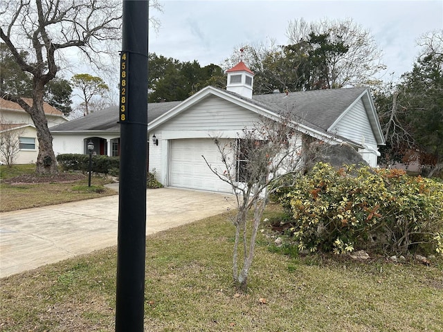 view of property exterior featuring a lawn and a garage