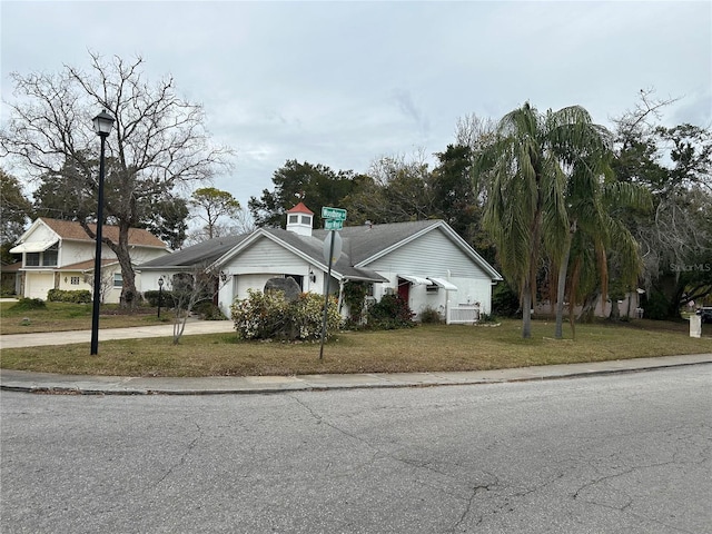 view of front of home with a garage and a front yard