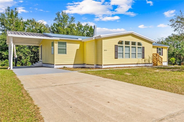 view of front of property with a front lawn and a carport