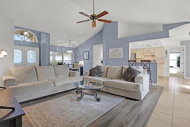 living room with wood-type flooring, a wealth of natural light, french doors, and ceiling fan