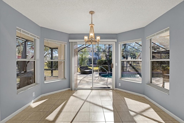 unfurnished sunroom with an inviting chandelier and a healthy amount of sunlight