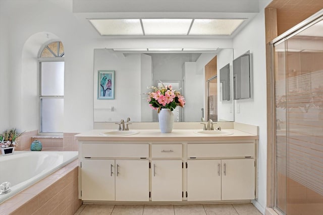 bathroom with shower with separate bathtub, vanity, and tile patterned floors