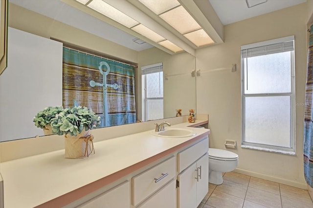 bathroom featuring vanity, toilet, and tile patterned flooring