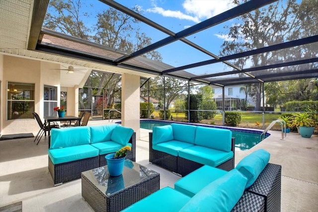 view of patio featuring ceiling fan, outdoor lounge area, and a lanai