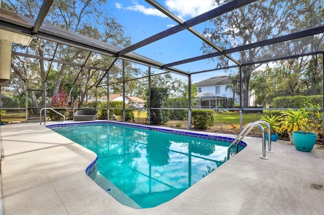 view of swimming pool with a patio area and glass enclosure