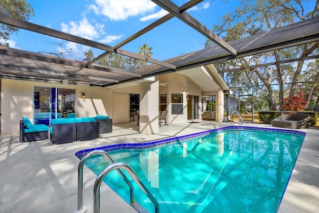 view of pool with a patio area, outdoor lounge area, and glass enclosure