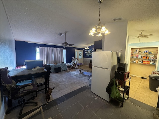 kitchen with ceiling fan with notable chandelier, a textured ceiling, dark tile patterned flooring, built in shelves, and white refrigerator