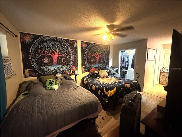 bedroom with ceiling fan and a textured ceiling