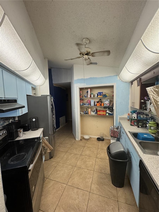 kitchen with a textured ceiling, black dishwasher, sink, range with electric cooktop, and light tile patterned floors