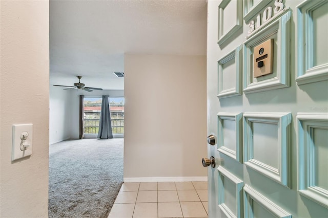 hall featuring light colored carpet