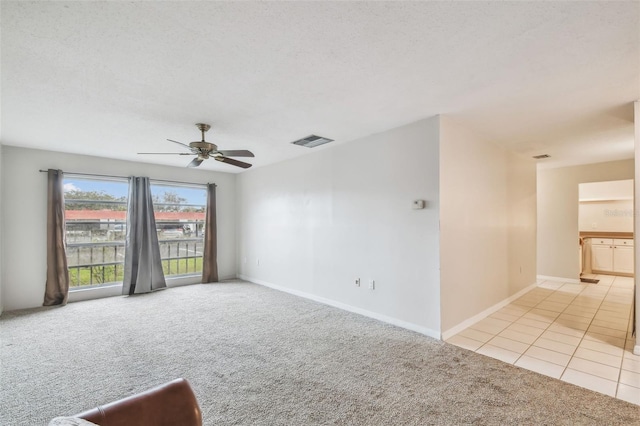 unfurnished room featuring ceiling fan and light colored carpet