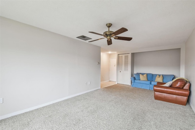 unfurnished living room featuring ceiling fan and carpet flooring