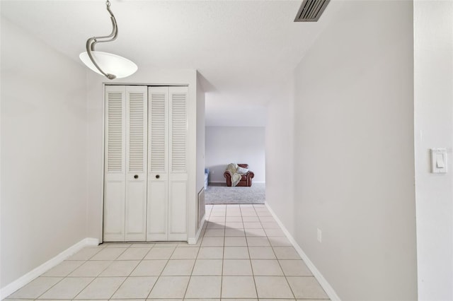 hallway featuring light tile patterned floors