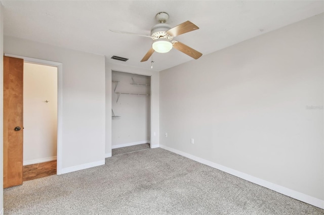 unfurnished bedroom with ceiling fan, a closet, and carpet floors