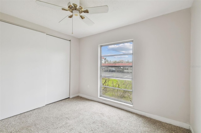 spare room featuring carpet floors and ceiling fan