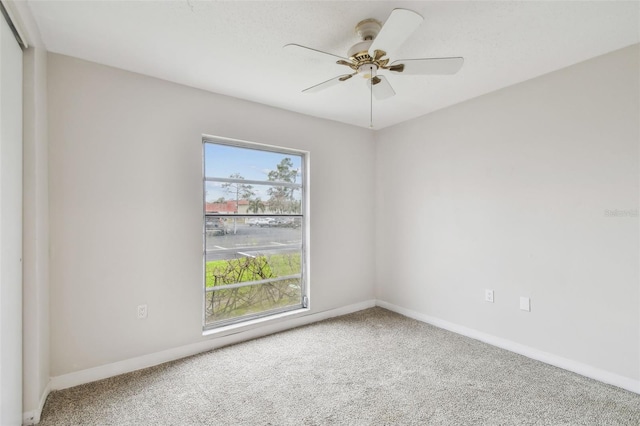 carpeted empty room with ceiling fan