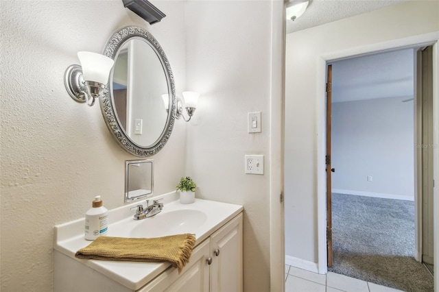 bathroom featuring a textured ceiling, vanity, and tile patterned flooring