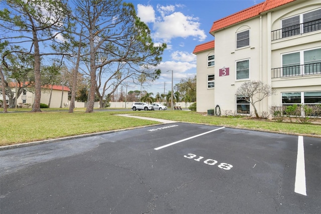 view of car parking featuring a lawn