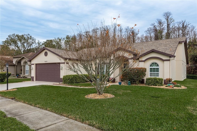 view of front of property with a front yard and a garage