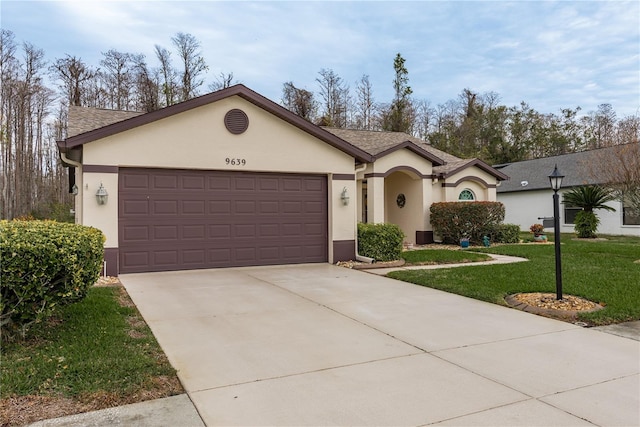 ranch-style home with a garage and a front yard