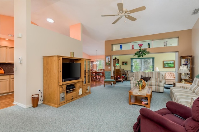 9639 Conservation Dr, New Port Richey, FL 34655 - carpeted living room with ceiling fan, vaulted ceiling, and baseboard heating