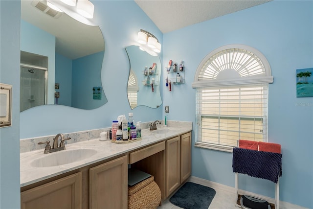9639 Conservation Dr, New Port Richey, FL 34655 - bathroom featuring a textured ceiling, tile patterned flooring, a shower with door, vanity, and vaulted ceiling