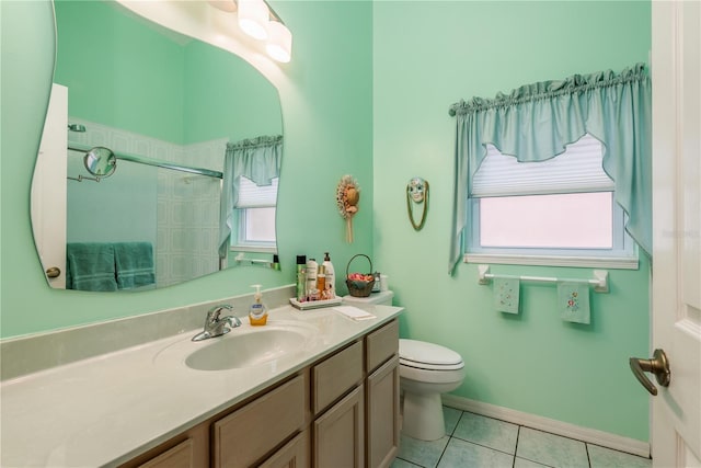 9639 Conservation Dr, New Port Richey, FL 34655 - bathroom featuring plenty of natural light, toilet, vanity, and tile patterned flooring