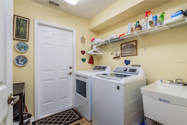 9639 Conservation Dr, New Port Richey, FL 34655 - clothes washing area featuring sink and separate washer and dryer