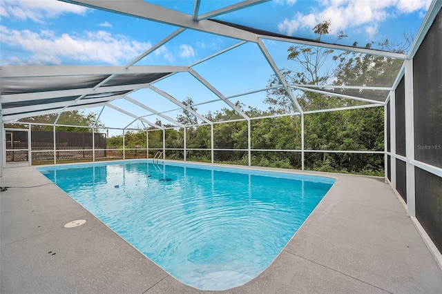 view of swimming pool with a patio and glass enclosure