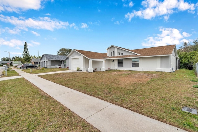 single story home with a garage and a front lawn