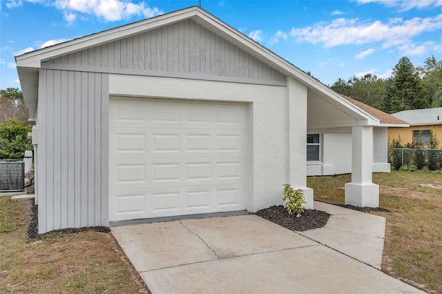 garage with central AC unit and a yard