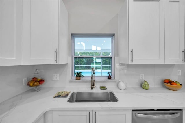 kitchen featuring white cabinetry, dishwasher, and sink