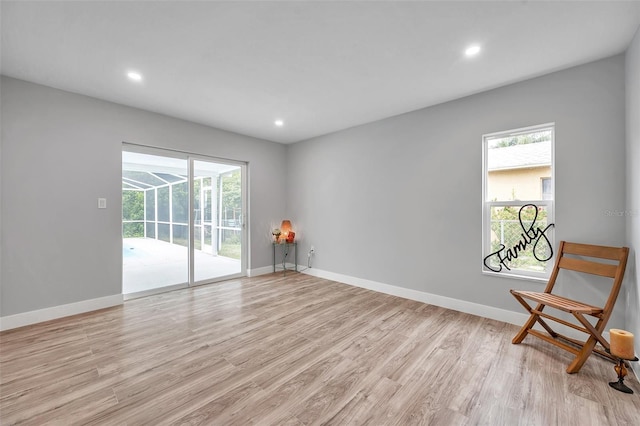 unfurnished room featuring light hardwood / wood-style floors and a wealth of natural light