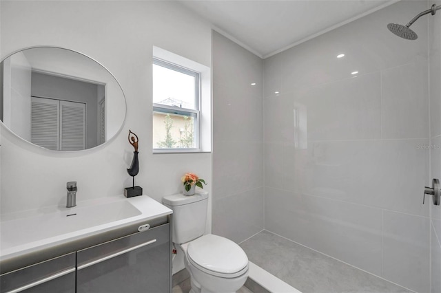 bathroom featuring toilet, vanity, and a shower