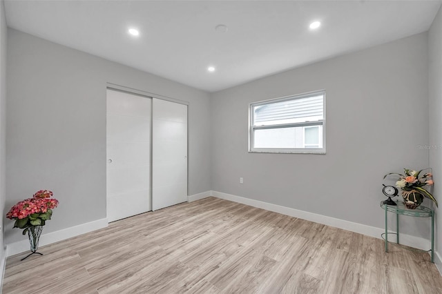 bedroom featuring a closet and light hardwood / wood-style flooring