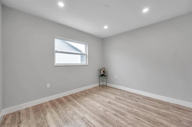 unfurnished room with light wood-type flooring