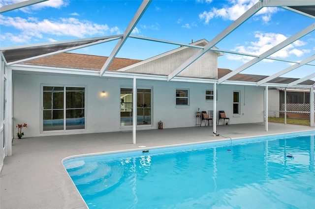 back of property featuring a lanai and a patio