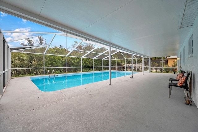 view of swimming pool with a patio area and a lanai