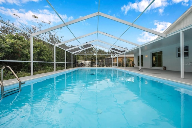 view of swimming pool featuring a patio area and a lanai