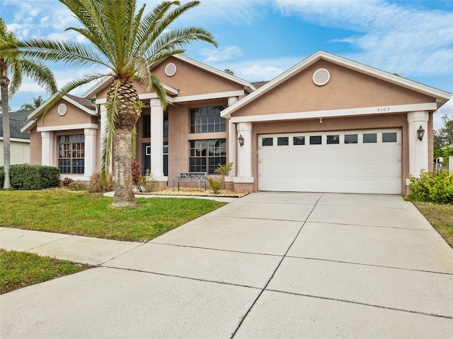 view of front of house with a front yard and a garage