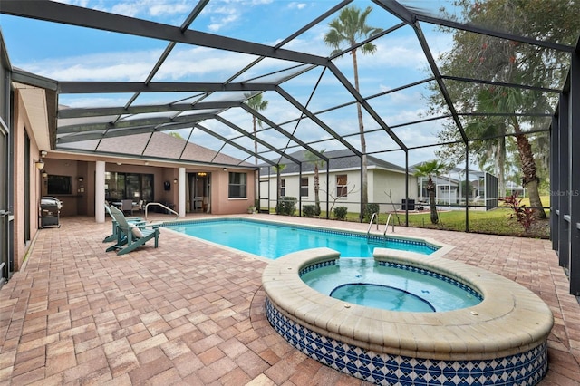 view of swimming pool with an in ground hot tub, a lanai, and a patio area