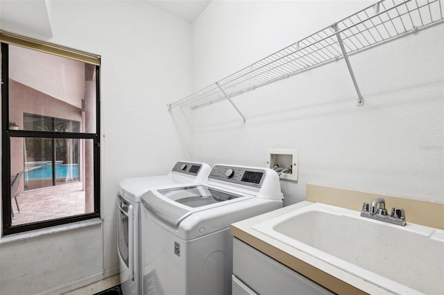 laundry area with sink and washing machine and dryer