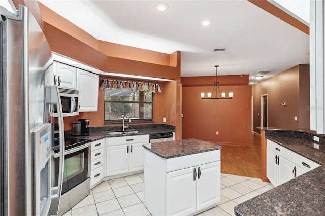 kitchen with white cabinets, sink, light tile patterned floors, and stainless steel appliances