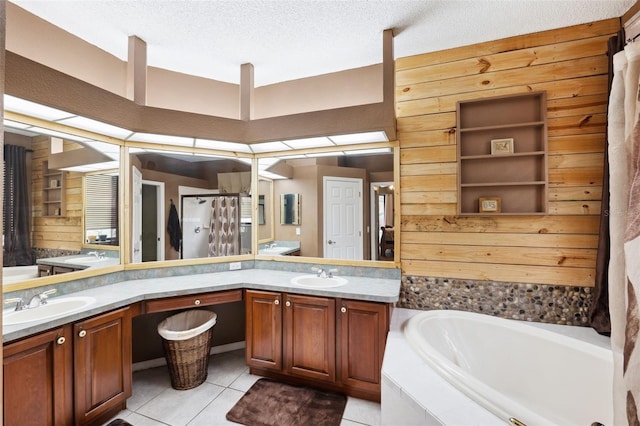 bathroom featuring vanity, tile patterned flooring, wooden walls, and shower with separate bathtub