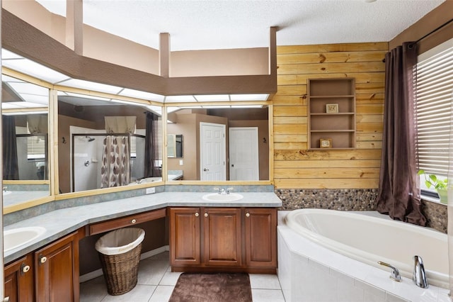 bathroom featuring tile patterned flooring, shower with separate bathtub, wood walls, and vanity