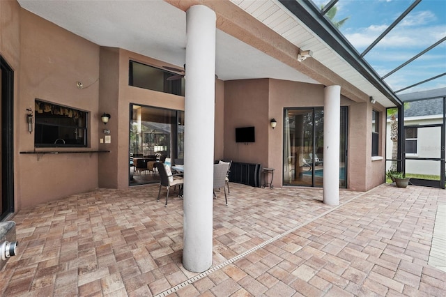 view of patio / terrace featuring glass enclosure